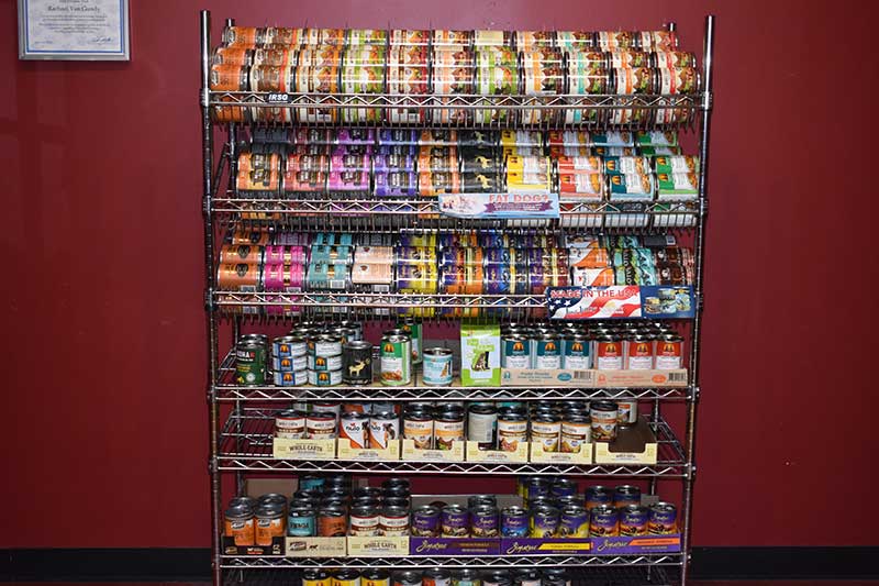A wall of all-natural canned food for dogs and cats